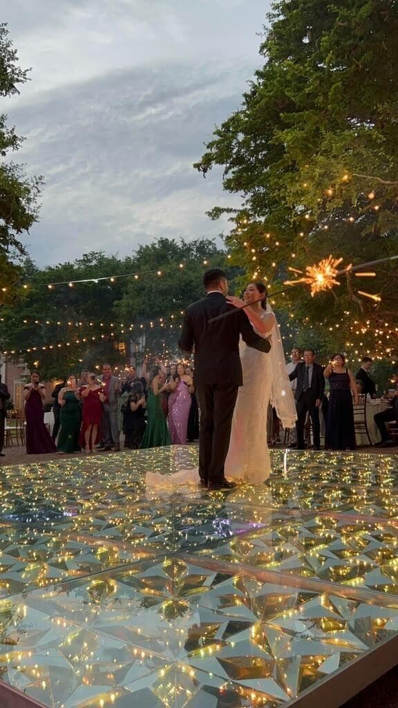 Couple dancing on a mirrored wedding dance floor