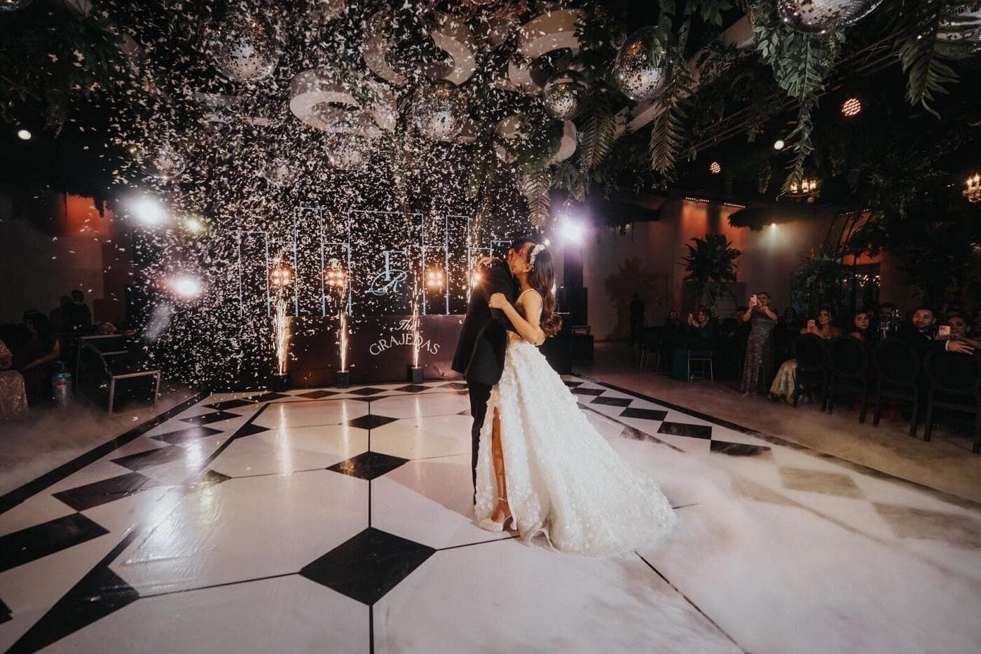 Newlyweds sharing a dance beneath celebration sparklers